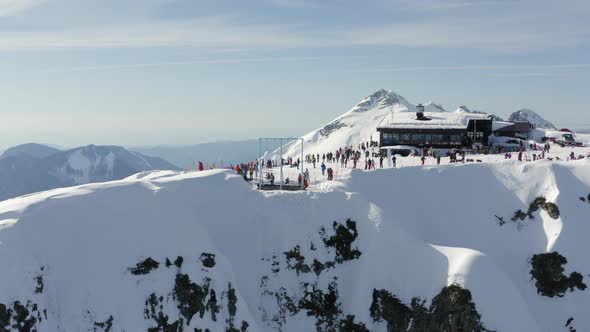 Active People Spending Time on Mountain Peak 2320 in Alpine Ski Resort alt