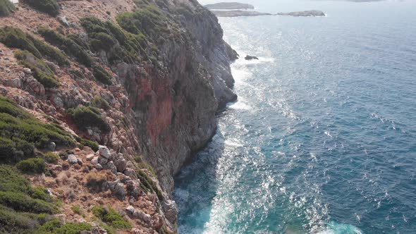 Aerial view of seaside cliff beach, foaming waves. Landscape Crete island Greece  alt