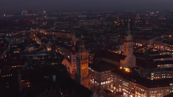 Flight Over the Rooftops of Munich City at Night in Germany Marienplatz and Beautiful Cathedrals alt