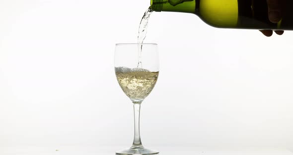 White Wine being poured into Glass, against White Background, Slow motion 4K