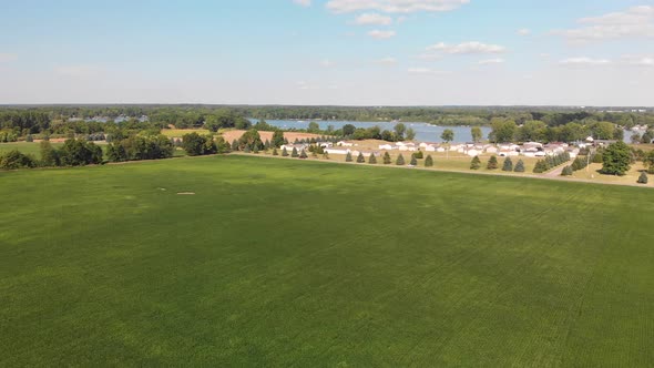  Countryside With Residential Buildings And Lake View. Aerial Landscape. alt