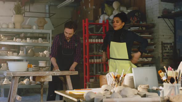 Woman and Man Are Cleaning Up Pottery Studio