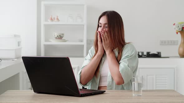 A Shocked Woman in Shirt Saying Wow Cover your Mouth with your Hand alt