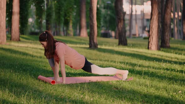Athlete Doing Flexibility Exercises in Park