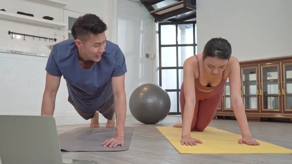 Asian couple push up on exercise mat