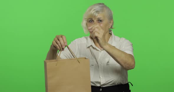 An Elderly Woman with Shopping Bag. Shopping. Presents. Chroma Key alt