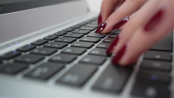Extreme Closeup Female Fingers Typing on Keyboard alt