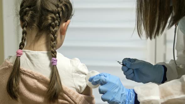Schoolage Girl Being Given the Vaccine