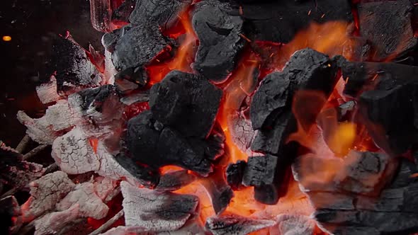 The close-up of the burning coals inside grill. Summer barbecue