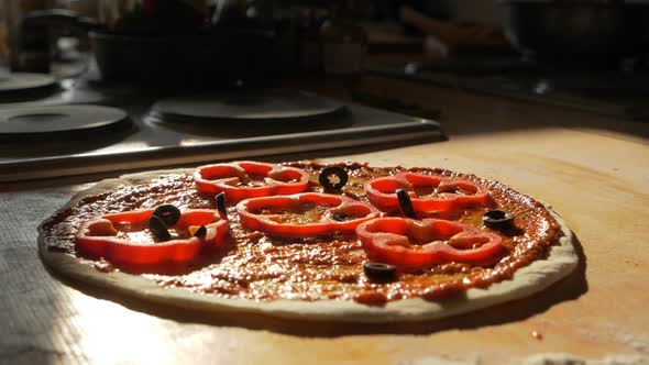 Topping Pizza Piece with Pickled Olives Before Baking