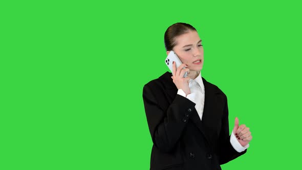Young Female Office Worker Talking on Mobile Phone Smiling on a Green Screen Chroma Key alt