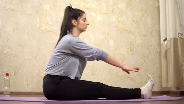 Woman Doing Stretching Exercise on Rag for Yoga Practice