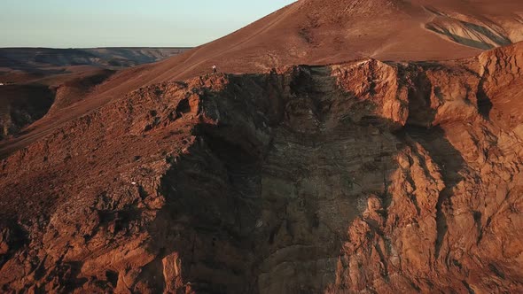 Drone View of Man on Motorbike Extremely Rides Across the Hills with Black Sea on Background 