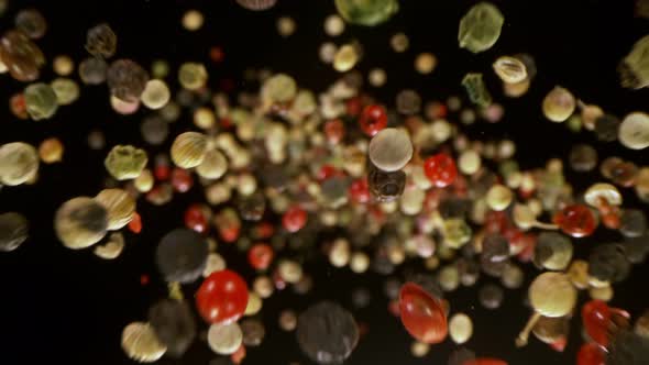 Super Slow Motion Detail Shot of Color Pepper Flying Towards Camera at 1000Fps alt