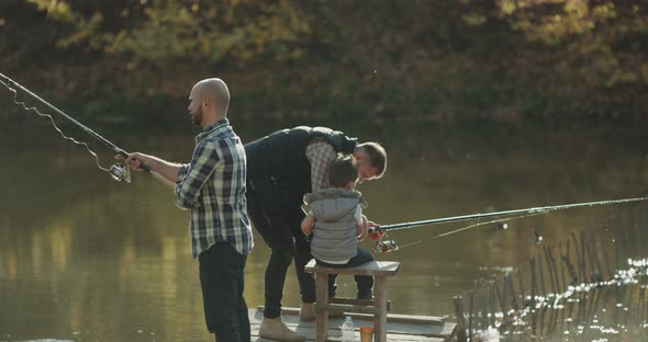 Closeup Fishing Men on the Bridge Catching Fish alt