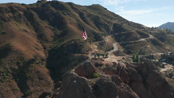 Red Blue and White Striped Flag Is Fluttering on Wind in Scenic Green Mountains alt