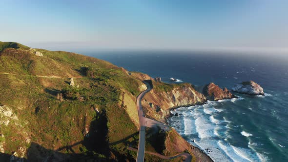 Drone Flying Above Highway Along Scenic Rocky Pacific Ocean Coastline, Summer alt