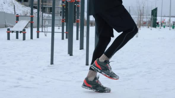 Man training outdoors on sports field in winter