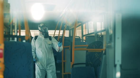 Bus Interior Is Getting Chemical Treatment From a Disinfection Worker. Covid-19 Coronavirus alt