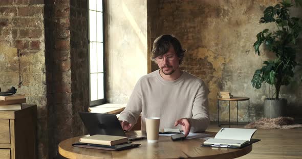 Timelapse of Serious Young Man Using Computer for Research and Creative Work alt