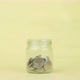 Woman hand putting the coin into a clear glass jar on yellow background, Saving money concept. - VideoHive Item for Sale
