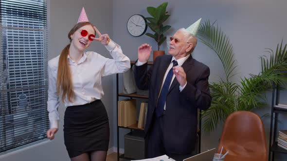 Two Joyful Collegues in Formal Suits Dancing Victory Dance Celebrating Success of Business Project alt