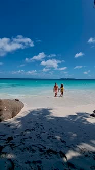 Anse Georgette Praslin Seychelles Young Couple Men and Woman on a Tropical Beach During a Luxury alt