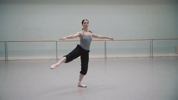 Ballerina rotates during rehearsal. Ballet dancer. Pirouette. Ballet pointe shoes.Beautiful rotation