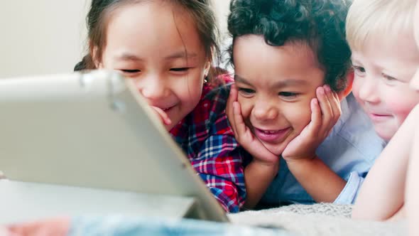 Multiethnic Kids Watching Cartoon on Tablet and Laughing