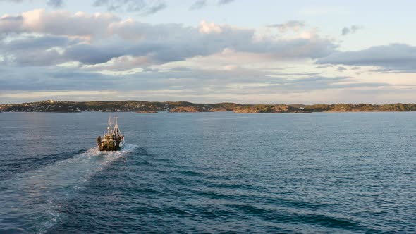 Fishing Trawler Sailing Along Skagerrak Strait With Backwash On Surface Near Arendal In Norway. - ae alt