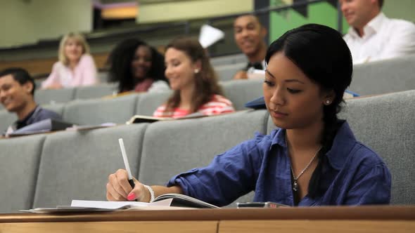 Students in class room throwing paper planes at student. alt