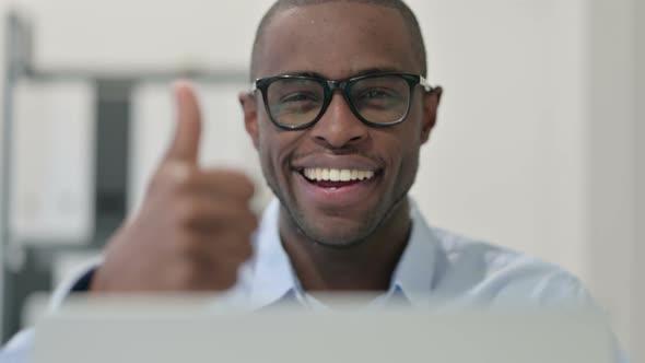 Close Up African Man Doing Thumbs Up Laptop alt