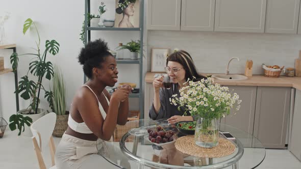 Lesbian Couple Enjoying Coffee in Cozy Kitchen alt