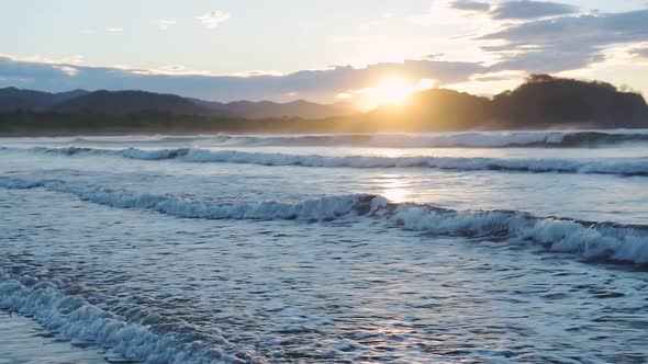Sea Waves Running To The Shore In Costa Rica With Bright Sun In The Background Captured By A Photogr alt