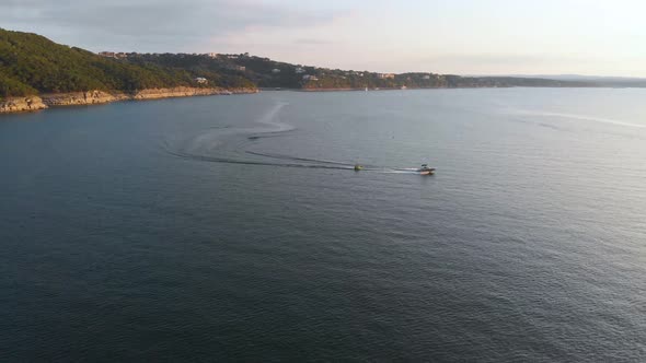 Drone shot of a boat pulling a tube on lake travis. Shot in Austin Texas on 9/10/20 alt