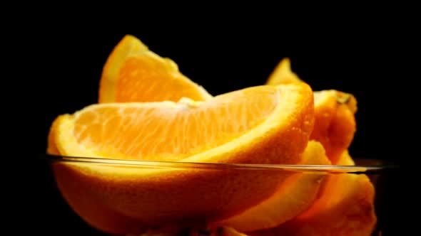 Orange Slices In A Plate On A Black Background Spins