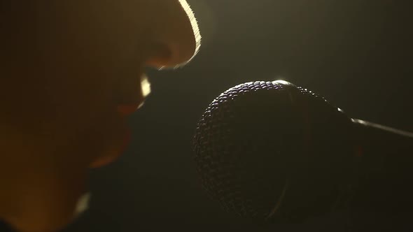 Woman singing to a microphone