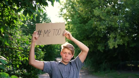 a Young Caucasian Teenager a Man in a Blue Shirt Holds a Cardboard Box in His Outstretched Arms alt