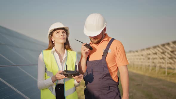 Technician and Investor Using Infrared Drone Technology to Inspect Solar Panels alt