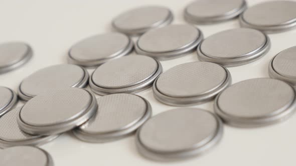 Used button batteries close-up 4K panning video