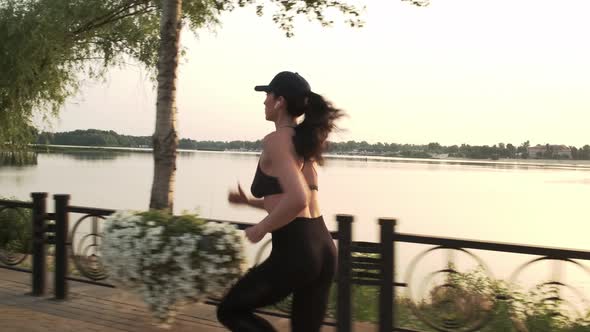 Fit Young Woman Running in Sunny Park Sprinting Fast Exercising Cardio Workout Training Focused alt