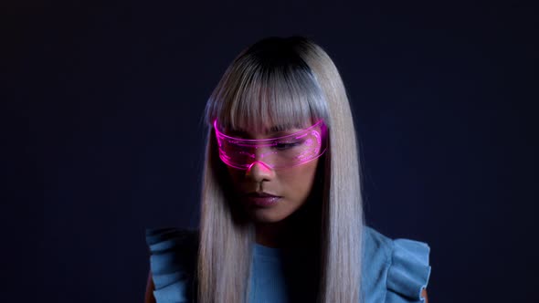 Young woman looking through futuristic light therapy glasses alt