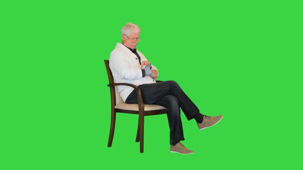 Senior Man Feeling Bad Measuring Blood Pressure on a Green Screen Chroma Key alt