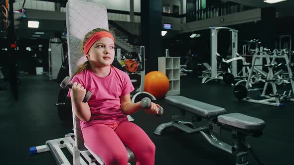 Fit Athletic Baby Girl Work Out with Dumbbell Doing Her Fitness Exercise