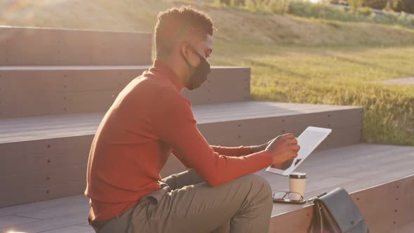 African American Businessman in Face Mask Working Outdoors alt