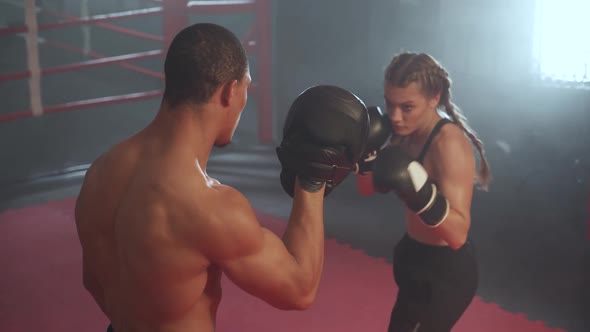 Female Fighter Trains Punches Strikes and Punching Focus Mitts Training Day with Coach in the Boxing alt