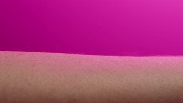 Hand Skin in Pink Neon Light Human Body Part and Ultraviolet Arm Surface Macro Shooting alt