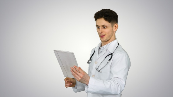 Attractive confident doctor dancing with tablet after reading alt