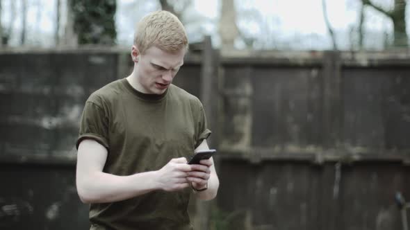 Army soldier checking mobile phone