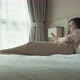 Thoughtful Young Caucasian Woman Using Smartphone While Sitting on Bedroom - VideoHive Item for Sale